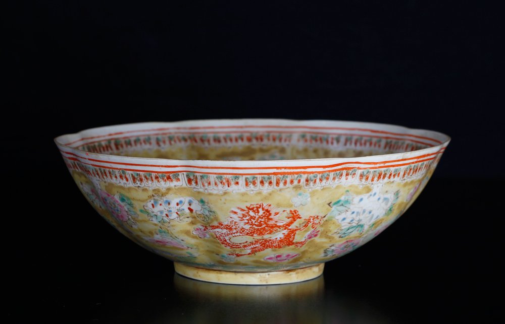 Chinese Eggshell Porcelain Bowl: Scalloped rim bowl, the interior and exterior depicting dragons and floral designs. Six character mark in iron red on underside. 2.75" H x 8.25" W. Excellent condition, with natural glaze roughness.