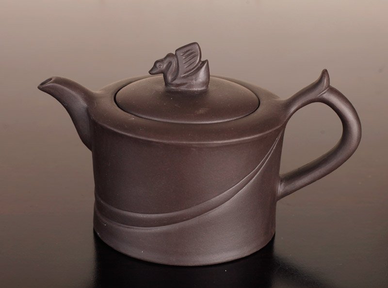 Chinese Zisha Clay Teapot: Plain teapot with single band around center tapering to handle, lid with swan. Interior lid stamped with teapot and character mark. Four character mark on underside. 3.125" H x 5.375" L. Excellent con