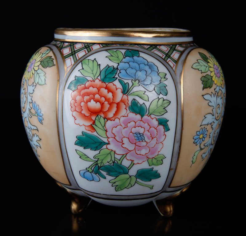 Antique Nippon Green Wreath Mark Biscuit Jar: Six protruding panels, each depicting flowers and highlighted in gilt, resting on three feet. The mouth is not perfectly circular, visible by the photos. Green wreath mark to underside. 6.25" H x 6" W