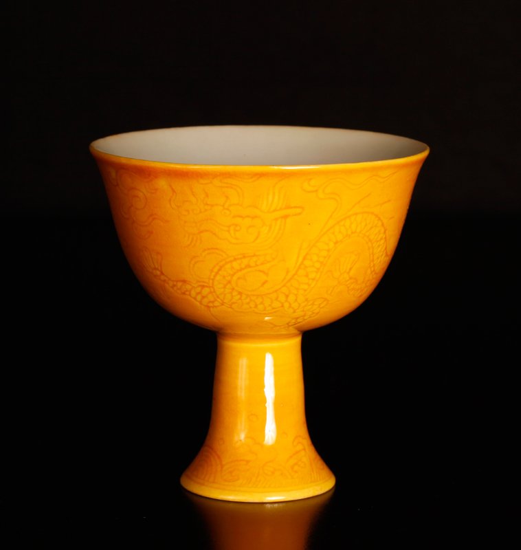 Chinese Incised Porcelain Wine Cup: In yellow, incised with dragons. Six character mark in blue on underside. 3.25" H x 3.25" Dia. Excellent condition.