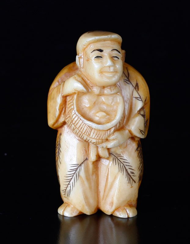 Japanese Carved Ivory Netsuke: This item is NOT available for international shipping. This item will only be shipped within the United States, excluding California. Carved to depict a male figure holding basket. Signature on unders