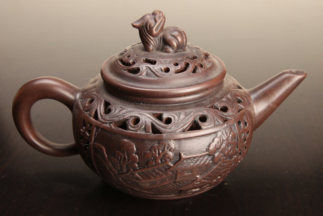 Chinese Zisha Clay Teapot: With openwork to lid and body, two areas on body of landscape designs, with separate well to interior so tea does not seep out. Four character mark to underside. 3.875" H x 6" L. Excellent condition.