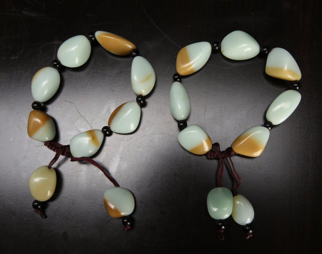 2 Chinese Hardstone Bracelets: Each with seven pebble form beads and two smaller at bottom. 3.25" Dia., adjustable. Excellent condition.