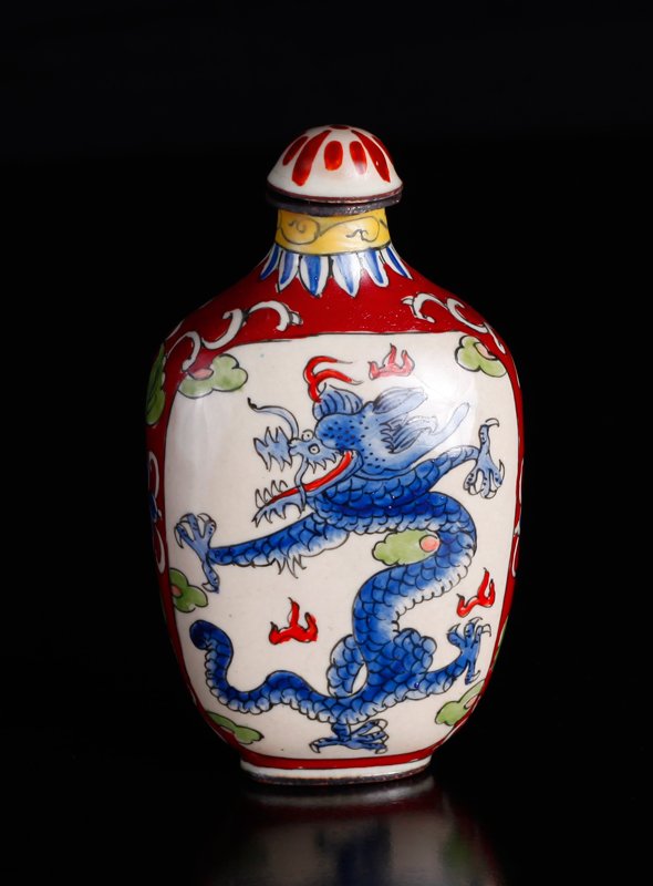 Chinese Enamel over Copper Snuff Bottle: Both sides decorated with blue dragons in red ground with floral and scrolling designs. Four character mark in blue on underside. 3.125" H x 1.75" W. Excellent condition.