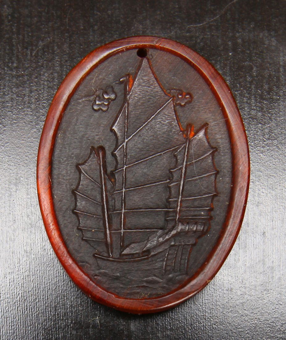 Chinese Carved Horn Pendant: Carved on one side to depict a sail ship. 2" H x 1.5" W. Excellent condition.