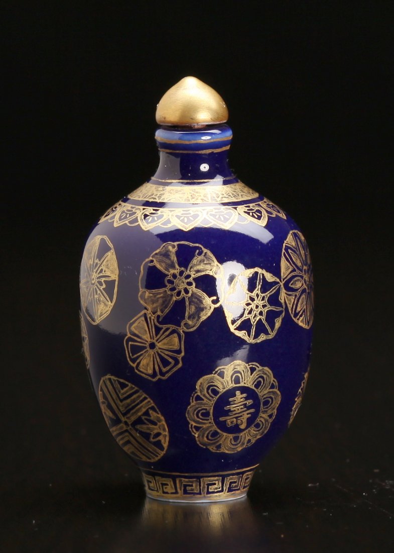 Chinese Porcelain Snuff Bottle: In cobalt and gilt with fu and shou patterns. Four character mark in gold and blue on underside. 2.875" H x 1.625" W. Excellent condition.