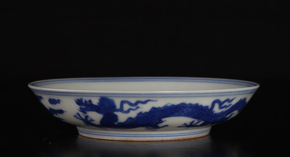 Chinese Blue & White Porcelain Brush Washer: The interior with five claw dragon, the exterior with five claw dragons, flaming pearl and ruyi clouds. Six character mark within two concentric circles in blue on underside. 1.125" H x 4.75" Dia. Exc