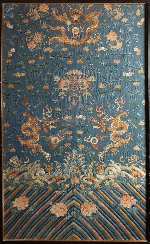 Chinese Embroidered Qing Chi’Fu Framed Silk Robe Fragm: Depicting Imperial 5 claw Dragons amongst Buddhist Emblems and Immortal Attributes above the mountains, rocks, lotus, clouds and ocean, with gold threading throughout. Framed behind glass. Framed meas
