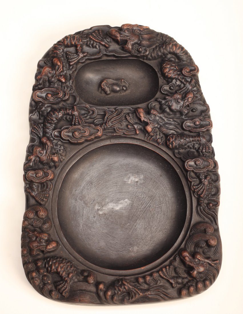 Chinese Carved Inkstone: With two wells, the remainder with dragons and ruyi clouds. Character mark to underside. 1" H x 8.75" L x 5.875" W. Excellent condition.