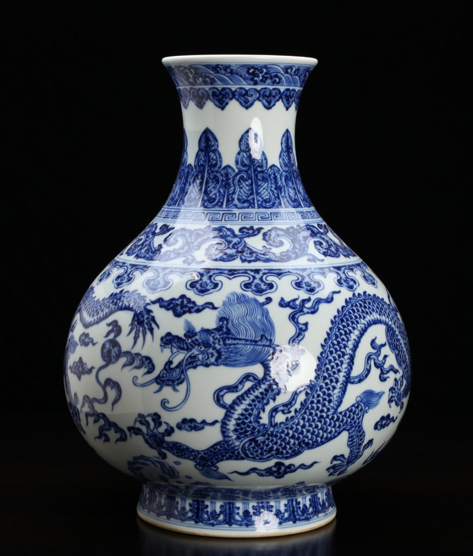 Chinese Blue & White Porcelain Vase: The exterior decorated with five claw dragons, flaming pearl, Greek key, stiff petals and scrolling designs. Six character mark in blue on underside. 11.625" H x 9.5" W. Excellent condition.