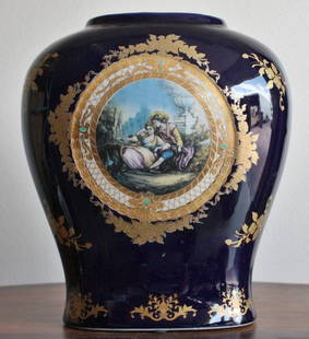 Ornate porcelain vase: Ornate blue porcelain vase in good condition with a mural relief and gold accents and releifs in very good condition measuring approx. 11hx11wx6.5d