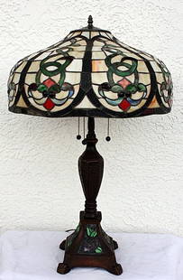 Ornate table lamp: Very ornate Table lamp containing qualit hand cut glass and jeweled glass in the shade. The work also contains hand cut glass in the base measuring approx. 30x20x20.