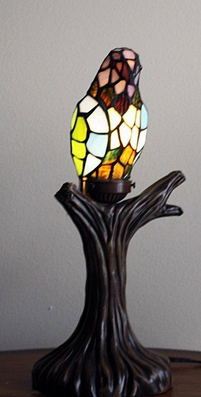"Parrot on Branch" lamp: "Parrot on Branch" lamp measuring approx. 18h x 7 x 7 with a lighting high quality glass parrot mounted on a branch stand. The lamp is in very good condition.
