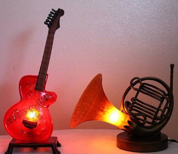 Lot of musical lamps: Lot of musical lamps containing one Guitar lamp measuring approx. 15x6x4 and a "French Horn" lamp measuring approx. 9x12x7. Very good condition.