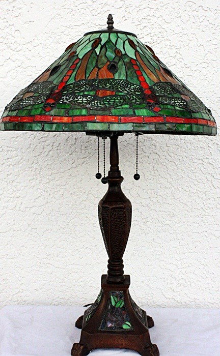 Jeweled dragonfly lamp w/ornate base: Jeweled dragonfly Table lamp containing qualit hand cut glass and jeweled glass in the shade and filagree over the dragonfly wings. The work also contains hand cut glass in the base measuring approx. 