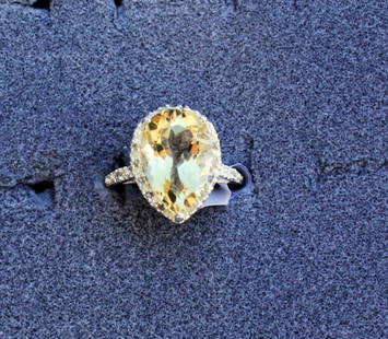 Ladies Citrine and Diamond ring: Ladies fancy Citrine and Diamond ring containing one pear shaped citrine of approx. 4.80 cts. and Diamonds of approx. .08 cts. Set in a very ornate detailed sterling silver setting. Mint condition.