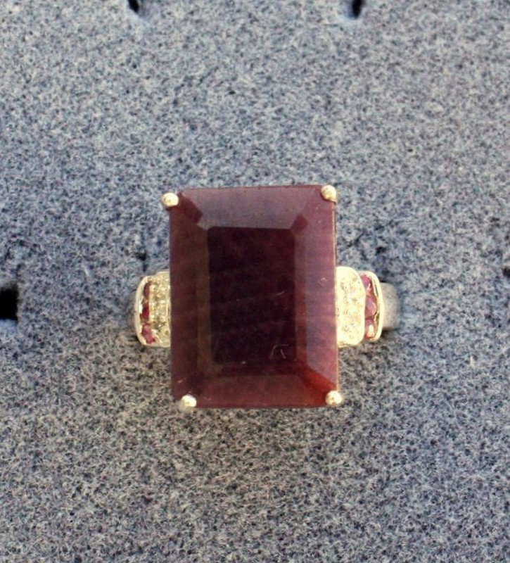 Ladies Ornate Ruby and Diamond Ring: Ladies fancy Classic Ruby ring containing one rectangular and round Rubies of approx. 9.50 cts. And Diamonds of approx. .03 cts. Set in a very ornate detailed sterling silver setting. Mint condition.