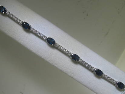 Blue Sapphire and Diamonds 14K White Gold Bracelet: Total Weightof 46 Round Diamonds - 1.00 ct of 9 oval cut Blue Sapphires - 5.28 cts 14K White Gold - 11.40 grams Appraised Value: $ 4,440.00