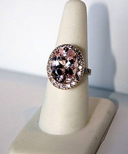 Ladies 14K Rose Gold Morganite and Diamond Ring: Ladies 14K rose gold ring mounted with one 7.76ct oval mixed cut natural Morganite and 30 bead set round brilliant cut diamonds. The ring weighs a total of 6.48g . The Morganite measures 15.70 x