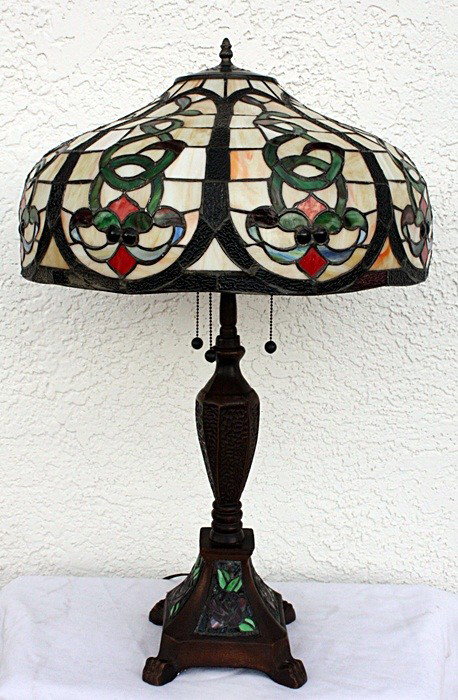 Ornate table lamp: Very ornate Table lamp containing qualit hand cut glass and jeweled glass in the shade. The work also contains hand cut glass in the base measuring approx. 30x20x20.