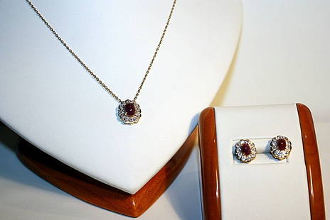 Ladies 14K Yellow Gold Diamond and Ruby Pendant and: Total Weight of 44 Round-cut Diamonds - 0.23 CT One Center oval cut RUBY - 0.96 CT Prong set in 14K Yellow Gold - 1.24 grams Appraised Value: $ 2,400.00 RUBY and Diamonds Earrings - Style# E3315AR