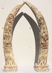 Pr. Inrticately carved "Tusk": One pair of very detailed carved tusk (bone) measuring approx. 28h. The works are in mint condition with intricately carved mythological carvings and accents.