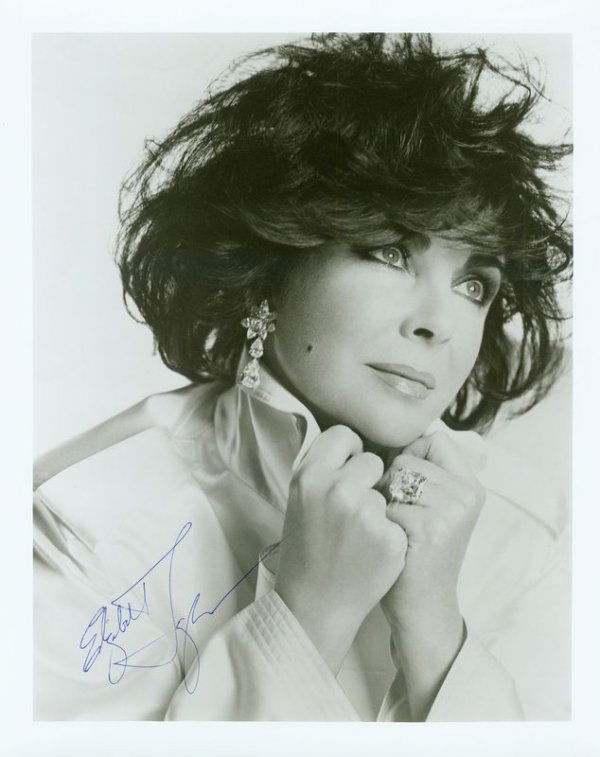 VINTAGE ELIZABETH TAYLOR SIGNED PHOTO: 947. ELIZABETH TAYLOR SP [Bruce Webber], b/w, 8"x10" quarter-length portrait, 1991. Boldly signed in blue ink across her image. Fine. Est: $150-250 Presented by Signature House
