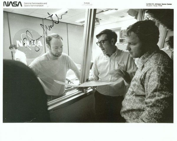EDGAR MITCHELL SIGNED PHOTOGRAPH: 463. EDGAR MITCHELL (b. 1930). Apollo 14 lunar module pilot and sixth Moonwalker, one of only 12 men to walk the lunar surface. SP, b/w, 10"x8" photo still in conversation with NASA colleagues. Signed