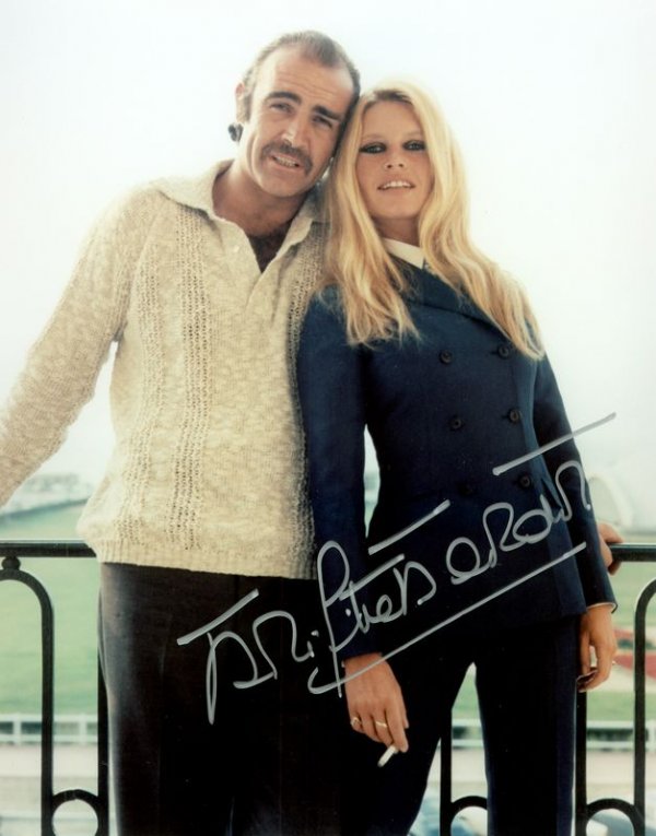 BRIGITTE BARDOT SIGNED PHOTOGRAPH: 692. BRIGITTE BARDOT Attractive SP, color, 7¾"x9½" three-quarter length standing portrait with leading actor Sean Connery. Darkly signed in silver felt tip across her image. Fine. Mat