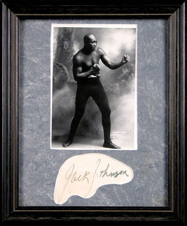 BOXER JACK JOHNSON SIGNED SIGNATURE W/PHOTO: 983. JACK JOHNSON (1878-1946). Heavyweight boxing champion, defeating Tommy Burns in a disputed world heavyweight title fight in Australia (1908) and former champion Jim Jeffries in 1