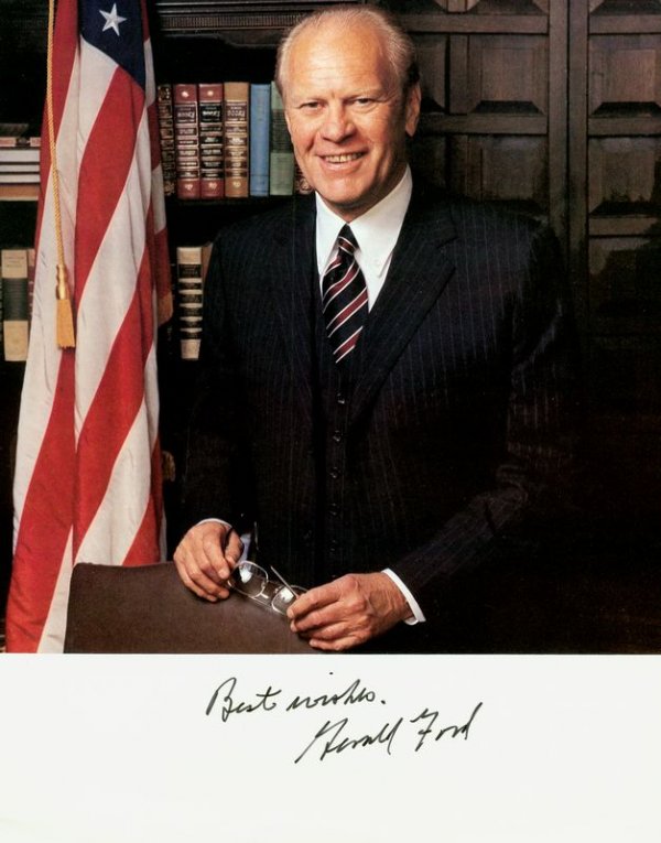 GERALD R. FORD SIGNED COLOR PHOTOGRAPH: 673. GERALD R. FORD Printed SP on thin paper, color, 8"x10" half-length standing portrait. Darkly signed beneath sentiment in white bottom border. Fine. Est: $50-100 Presented by Signature House<