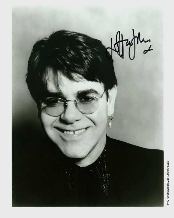 ELTON JOHN SIGNED PHOTOGRAPH: 971. ELTON JOHN (b. 1947). Enduringly popular British recording artist appearing in Tommy in 1975, receiving multiple awards for his work; knighted in 1998. SP, b/w, 8"x10" publicity bust portrait of 