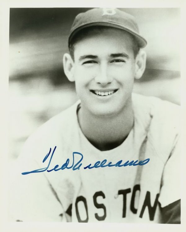 TED WILLIAMS SIGNED PHOTOGRAPH: 1112. TED WILLIAMS Reproduced SP, b/w, 8"x10" quarter-length portrait of the young Red Sox player. Darkly signed in blue felt tip. Fine. JSA LOA. Est: $100-200 Presented by Signature House
