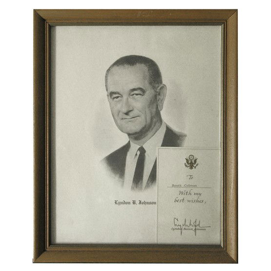 LYNDON B. JOHNSON: Boldly signed presidential card with gold embossed eagle, 3¼"x5". Fine. Mounted with large vintage printed bust portrait vignette under glass within attractive simple wood frame. Overall 9½"x12".