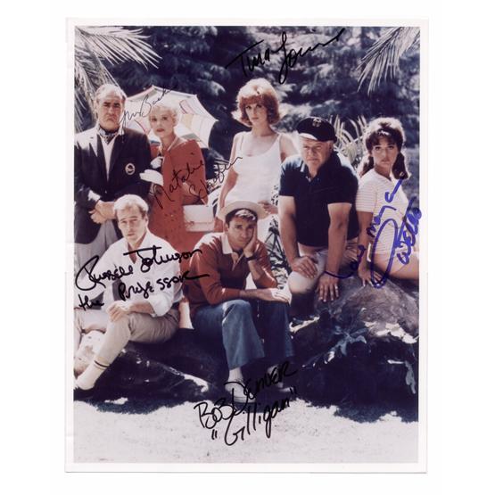 [GILLIGAN'S ISLAND]: Popular television comedy (1964-66) relating the adventures of island castaways that achieved great fame in syndication. SP, color, 8"x10" portrait of all seven cast members seated around a table on t