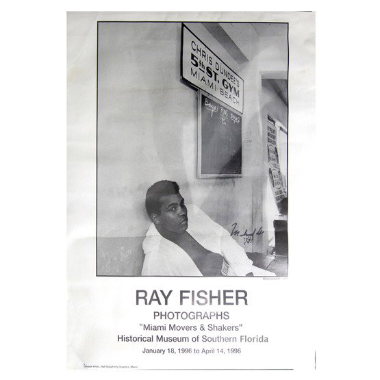 MUHAMMAD ALI: Poster from "Miami Movers & Shakers" museum series featuring photographs by Ray Fisher, overall 18"x23¾". Presented is his 1971 b/w, 12¾"x16" seated portrait of the young boxer wearing boxing trunks