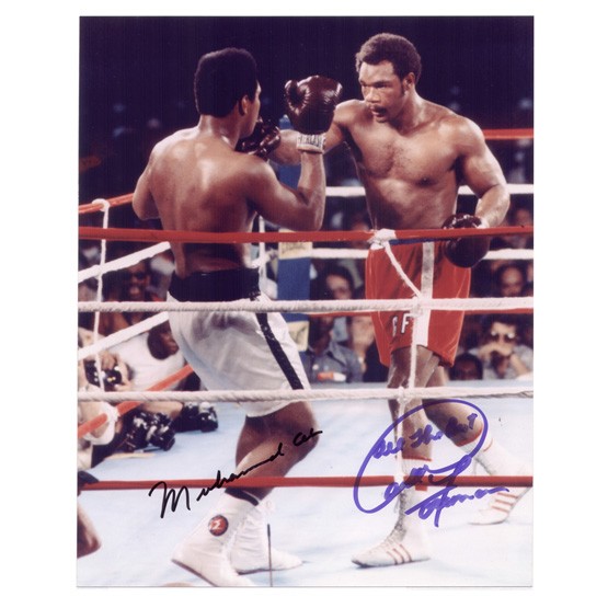 [HEAVYWEIGHT CHAMPIONS]: Two heavyweights, MUHAMMAD ALI and GEORGE FOREMAN staged the "Rumble in the Jungle" in Zaire in 1974. Ali won in round eight in a KO. SP, color, 8"x10" action still in the ring. Each has signed in bla