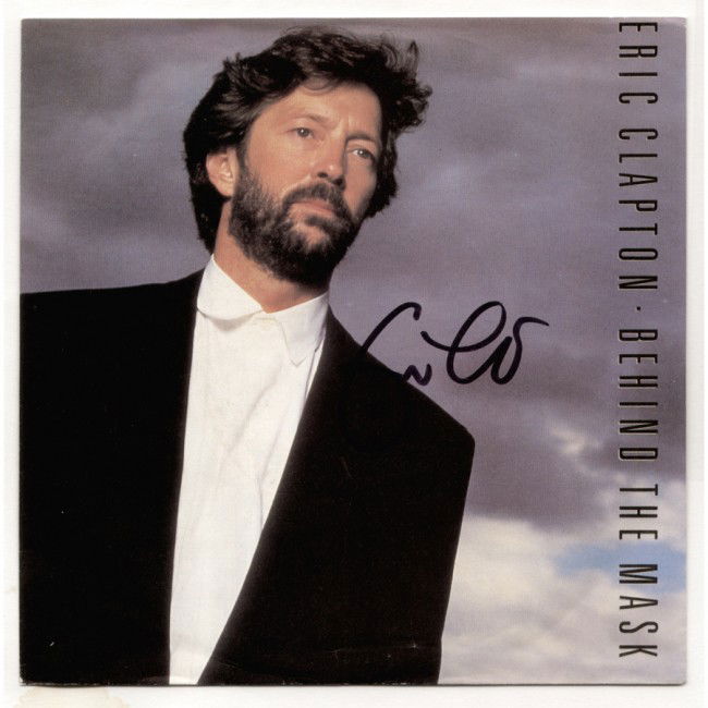 ERIC CLAPTON: Attractive color record sleeve featuring his image titled "Eric Clapton Behind The Mask." Boldly signed in black felt tip. Light edge wear; else Fine. The 7" 45 RPM recording present.