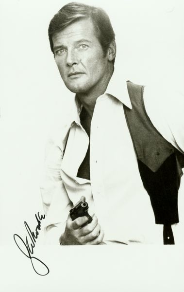 ROGER MOORE SIGNED PHOTO: 1200. ROGER MOORE (b. 1927). Suave English leading actor known primarily for his television starring role in The Saint (1962-69) and as Sean Connery's successor in the role of James Bond (1973-85). SP