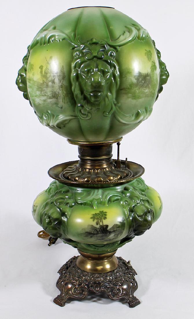 VICTORIAN GONE WITH THE WIND LAMP: GWTW Victorian era molded lion mask and Arabian scene electrified oil lamp. Approx 26" tall. Chip on base.