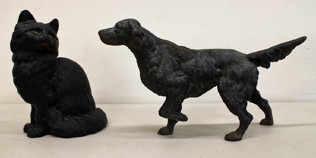(2) VINTAGE CAST IRON CAT & DOG DOORSTOPS: A black cat doorstop 9" tall and a pointer dog 14" long.