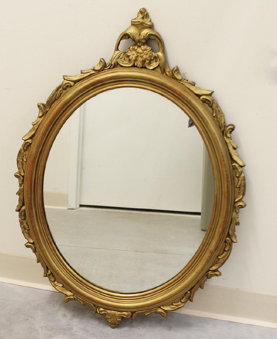 ANTIQUE OVAL GILT MIRROR: Carved wood gold mirror. 23" x 33"