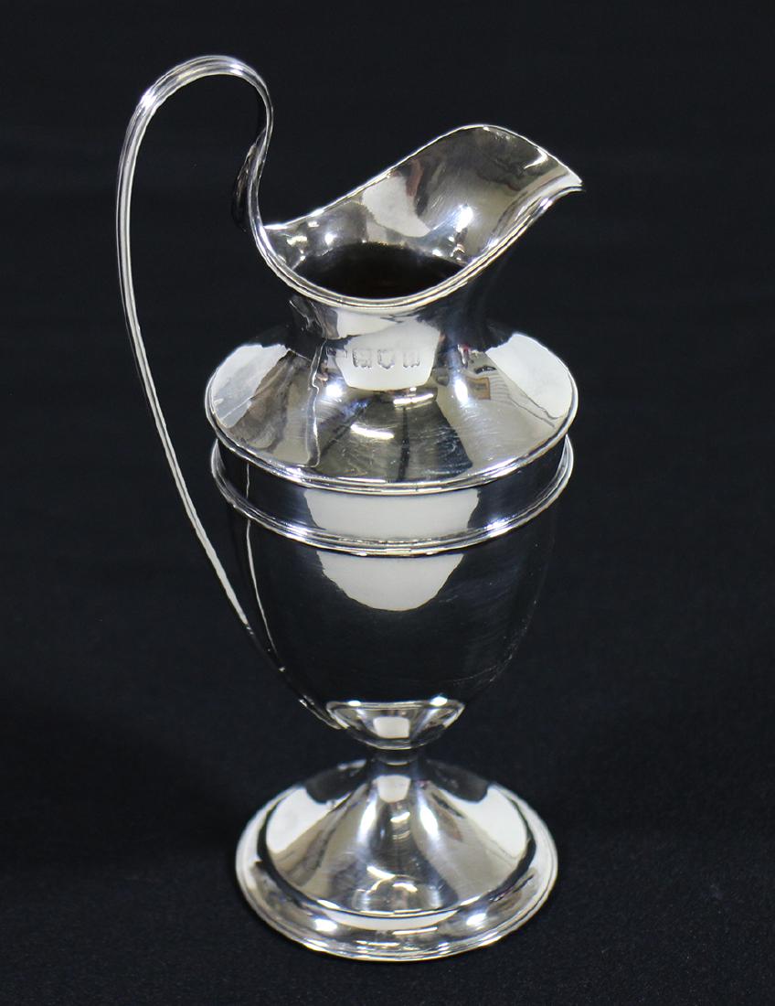 ENGLISH STERLING SILVER CREAMER: English hallmarked sterling silver creamer (Hallmarks appear to be London, Philip Hanson Abbot silversmith, 1928) 6 1/4" tall to handle, small indentation to side. 3.65 OZT.