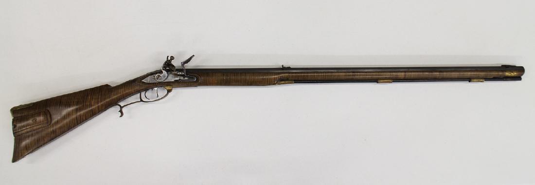 .54 CALIBER FLINTLOCK FULL STOCK LONG RIFLE: Flintlock .54 caliber full stock long gun with a curley maple stock. Made by H. White (brass inlay in top of barrel). Wooden slide patch box cover brass hardware. Silver thumb inlay on top of wrist. S