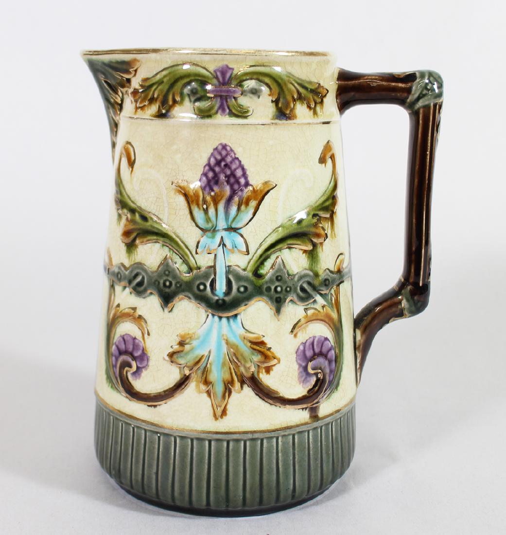 RORSTRAND SWEDEN MAJOLICA PITCHER: Majolica handled pitcher with a foliate and floral design. 7 1/4" tall