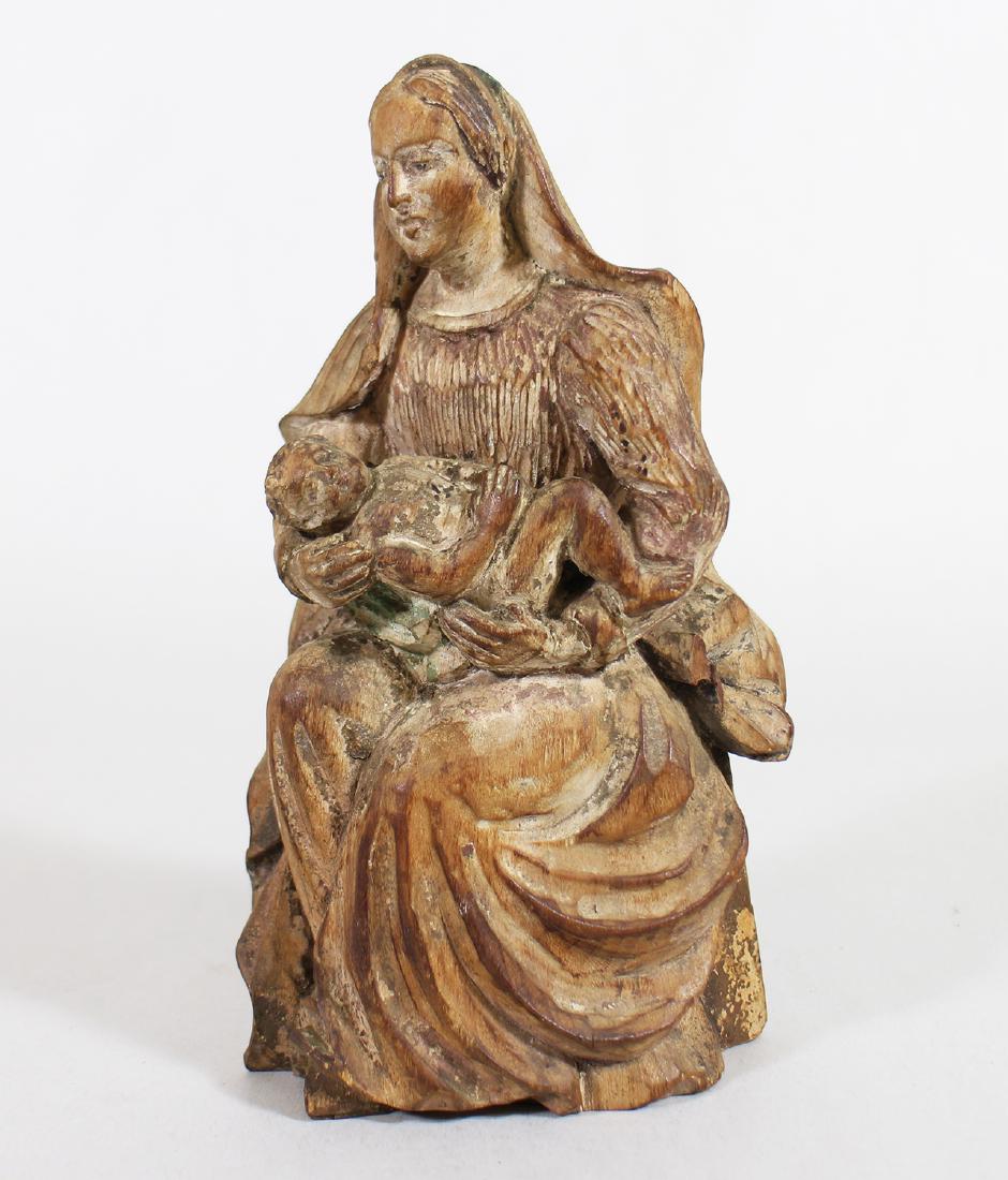 19TH CENTURY BAVARIAN MADONNA & CHILD: Early 19th century Bavaria wood Madonna & Child. The Madonna, seated in a right angled position, cradles the naked Child in her lap. She faces straight ahead, her mantle falling over her right shoulde