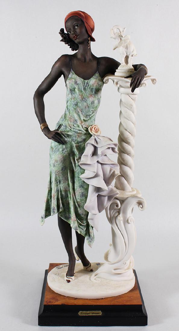 GIUSEPPE ARMANI FIGURINE MAHOGANY: Giuseppe Armani figurine Mahogany woman with elephant sculpture # 194. Numbered 668/5000. 17.5" Tall. Includes original box.