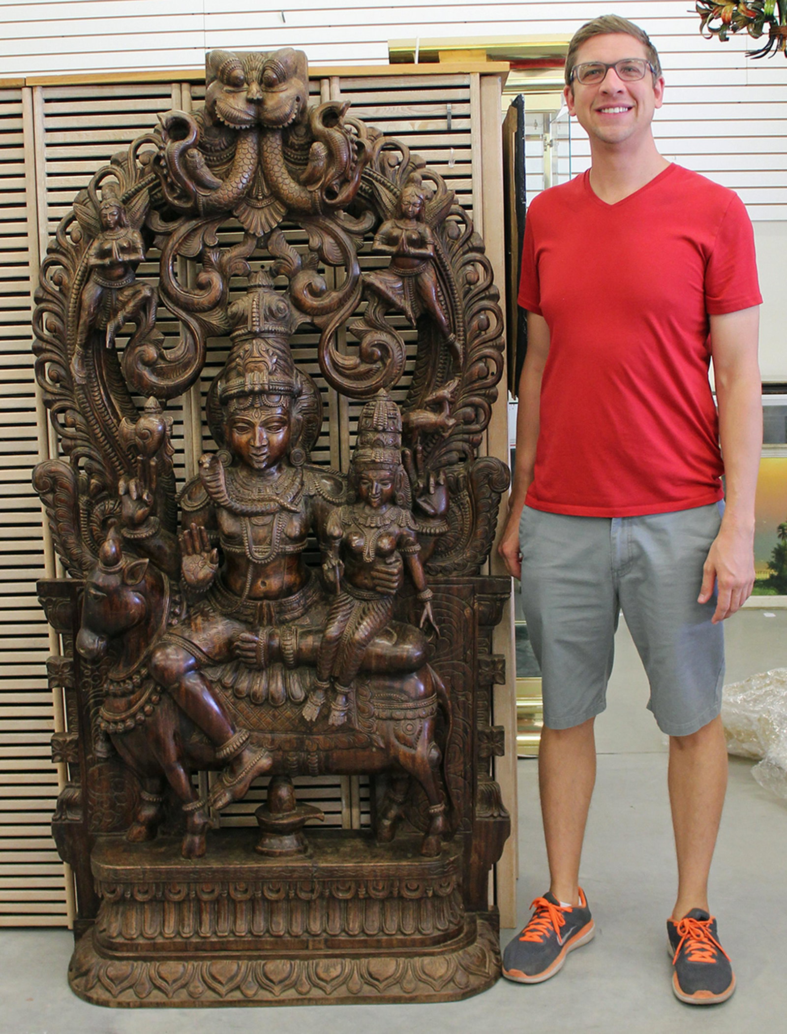 CARVED HINDU STATUE: Stunning high relief carved wood Hindu statue of a goddess sitting on a donkey or cow with child and cobra snake. Very detailed. Measures 73.5" tall 39" wide.