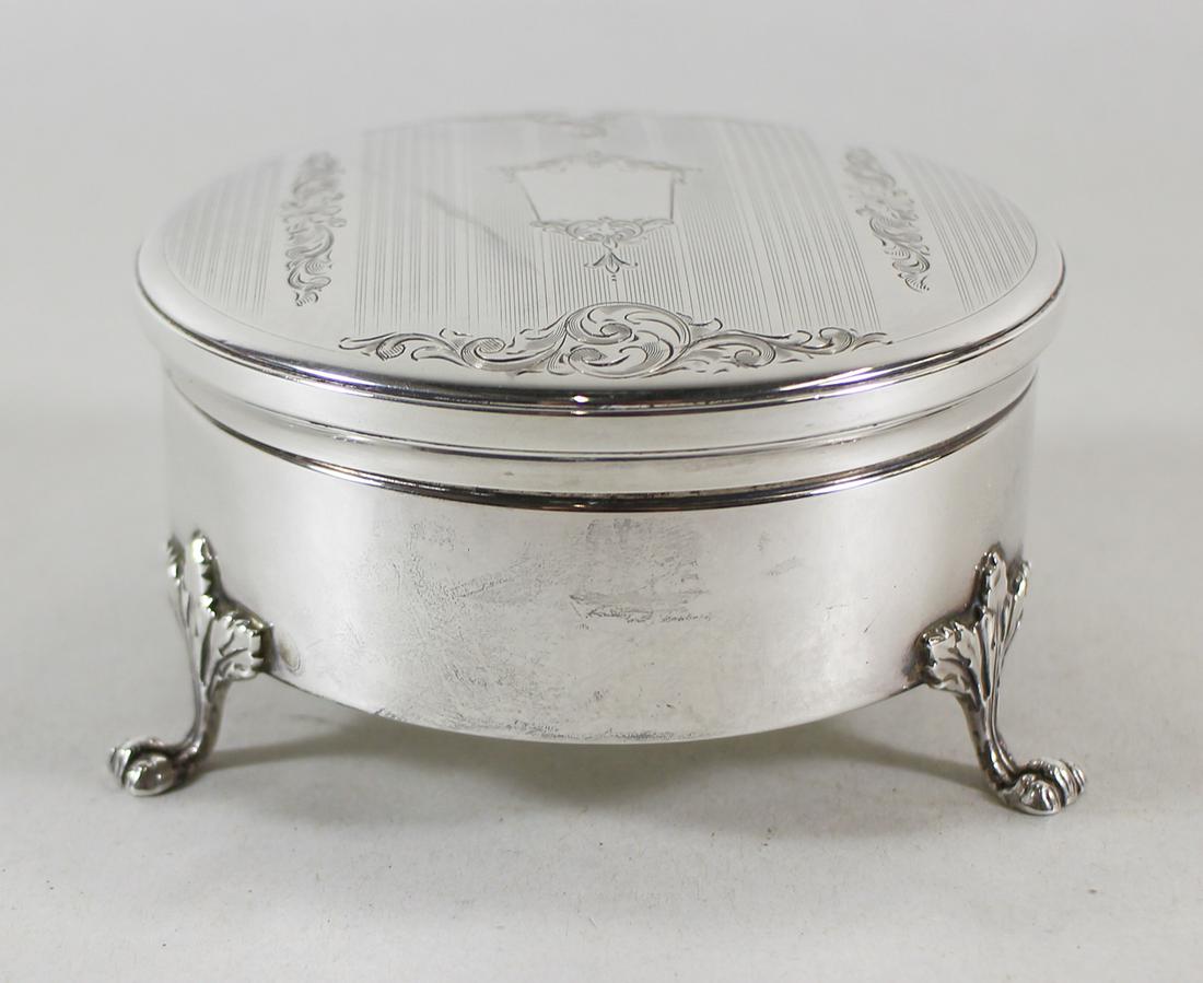 BIRKS STERLING SILVER FOOTED JEWELRY BOX: Birks sterling silver round powder dresser jar / jewelry box with paw feet and hand chased lid. Weighs 5.5 OZT and measures 3.75" wide 2" tall.