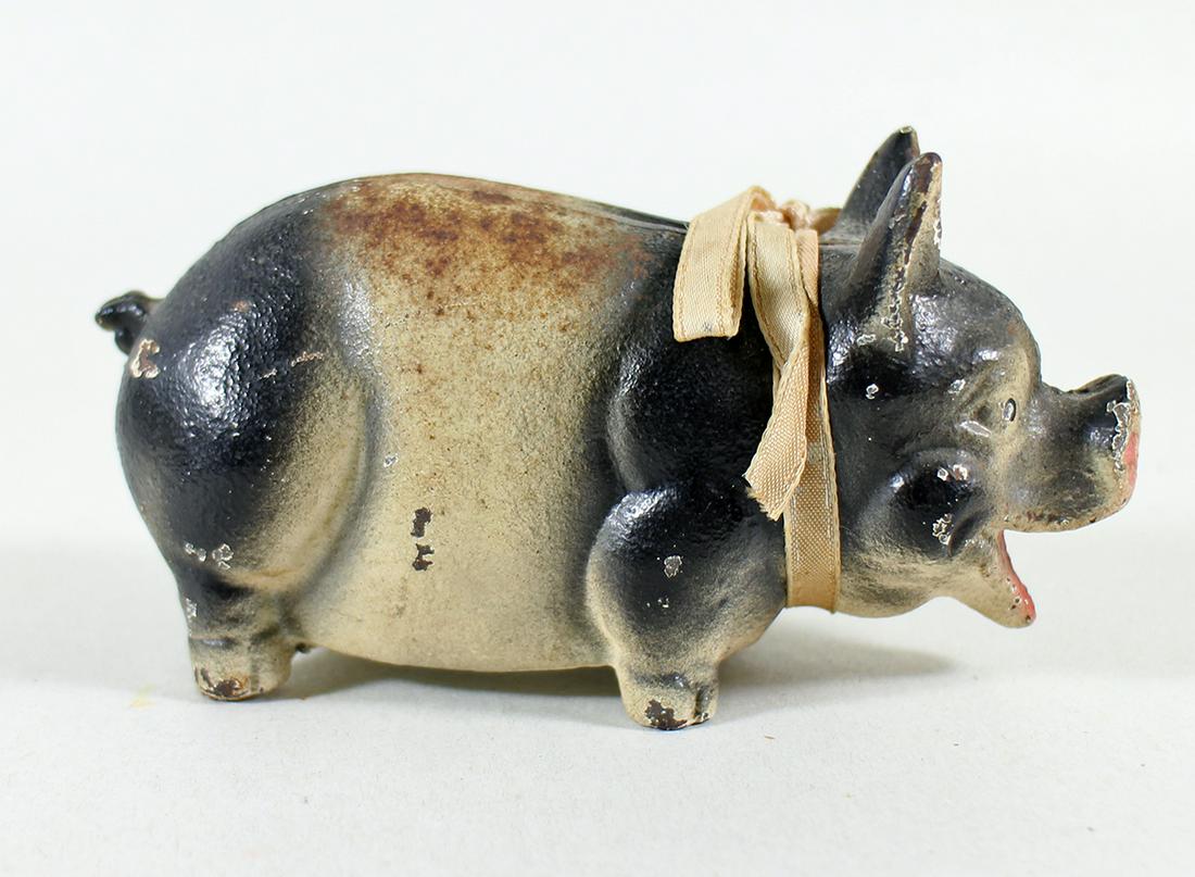 CAST IRON PIGGY BANK: Small cast iron painted pig bank. 5.25" long.